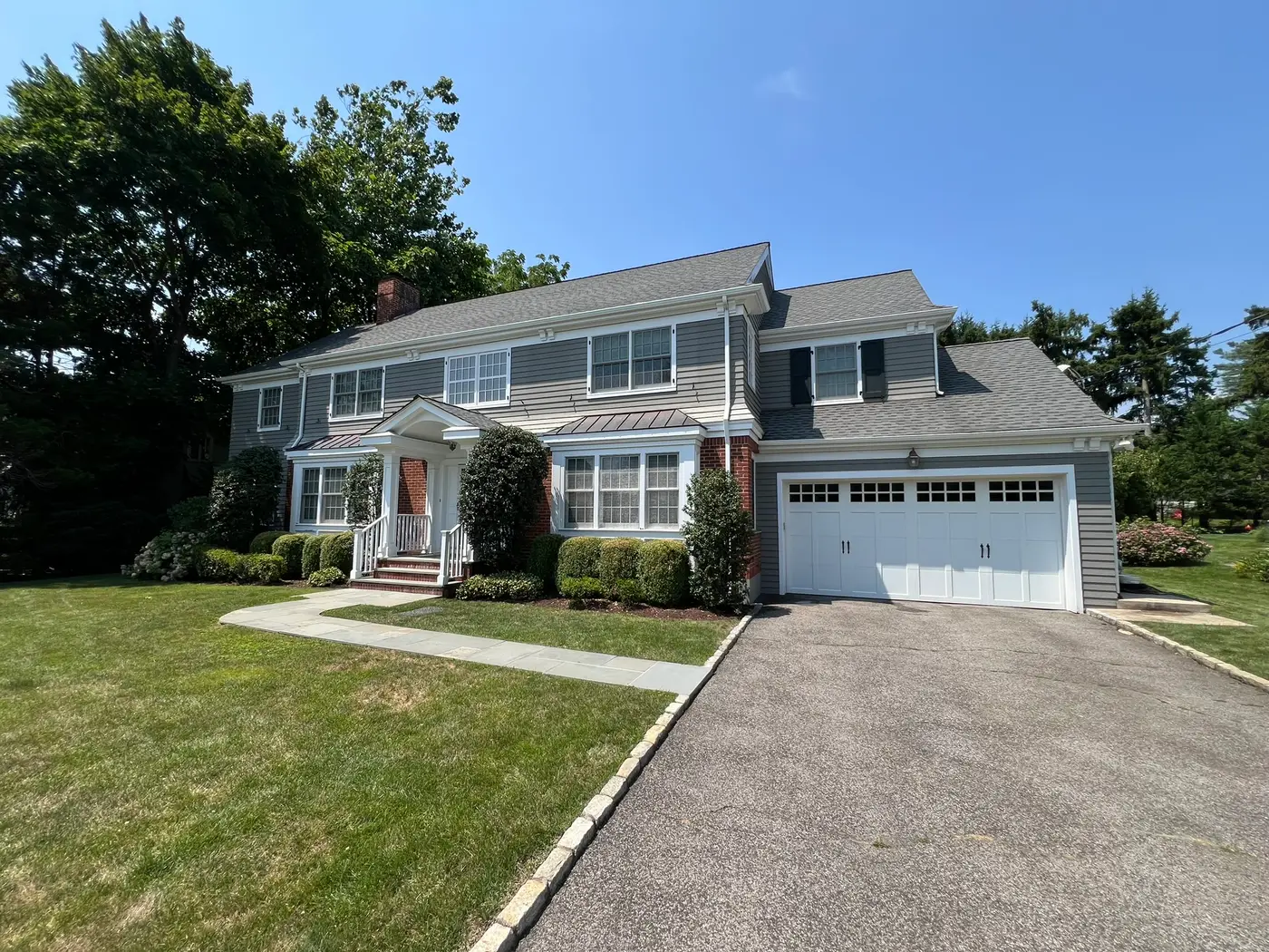 Professional painters working on a colonial-style home in Westchester County